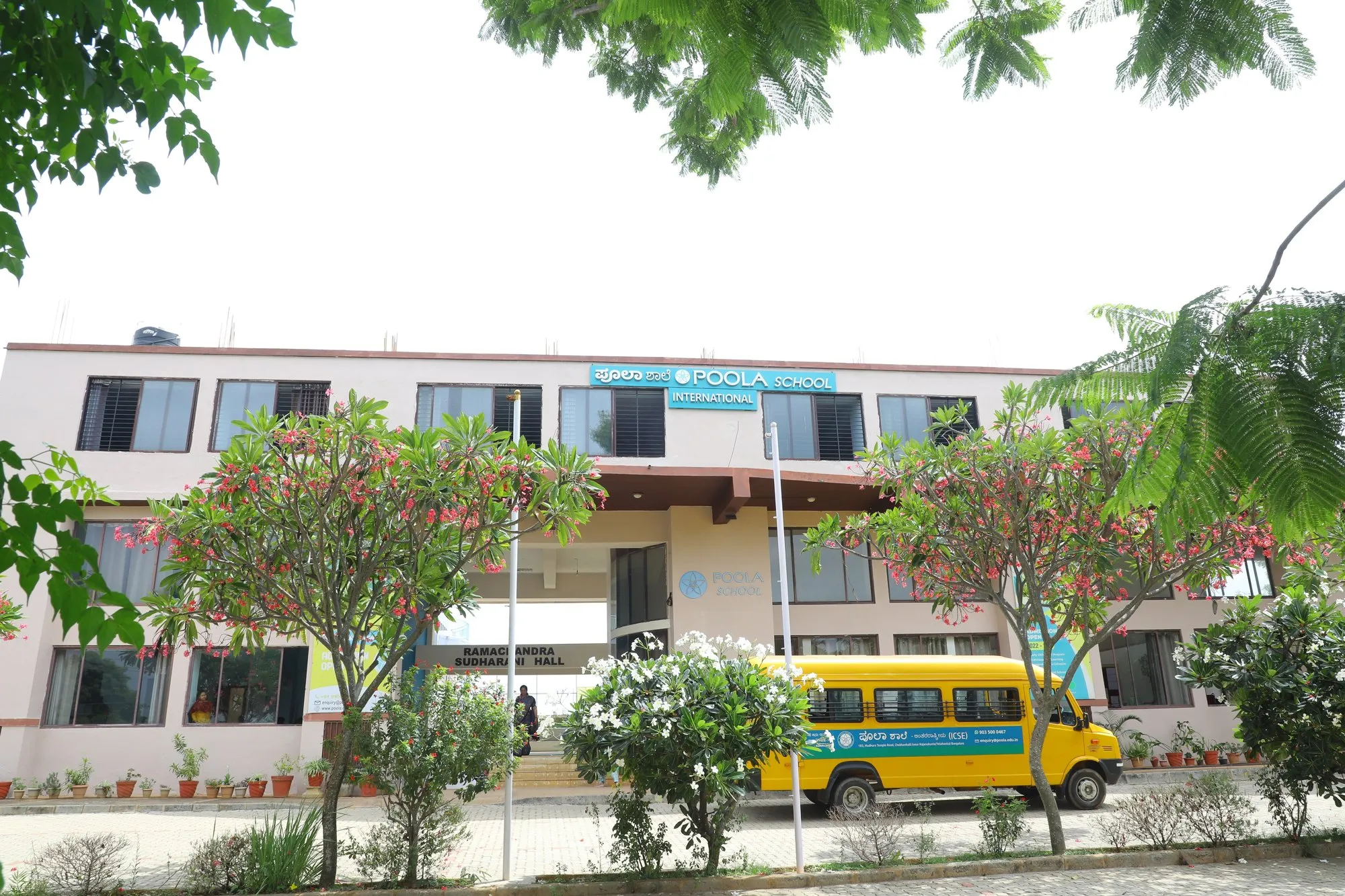 The front of the Poola School building with the school bus
