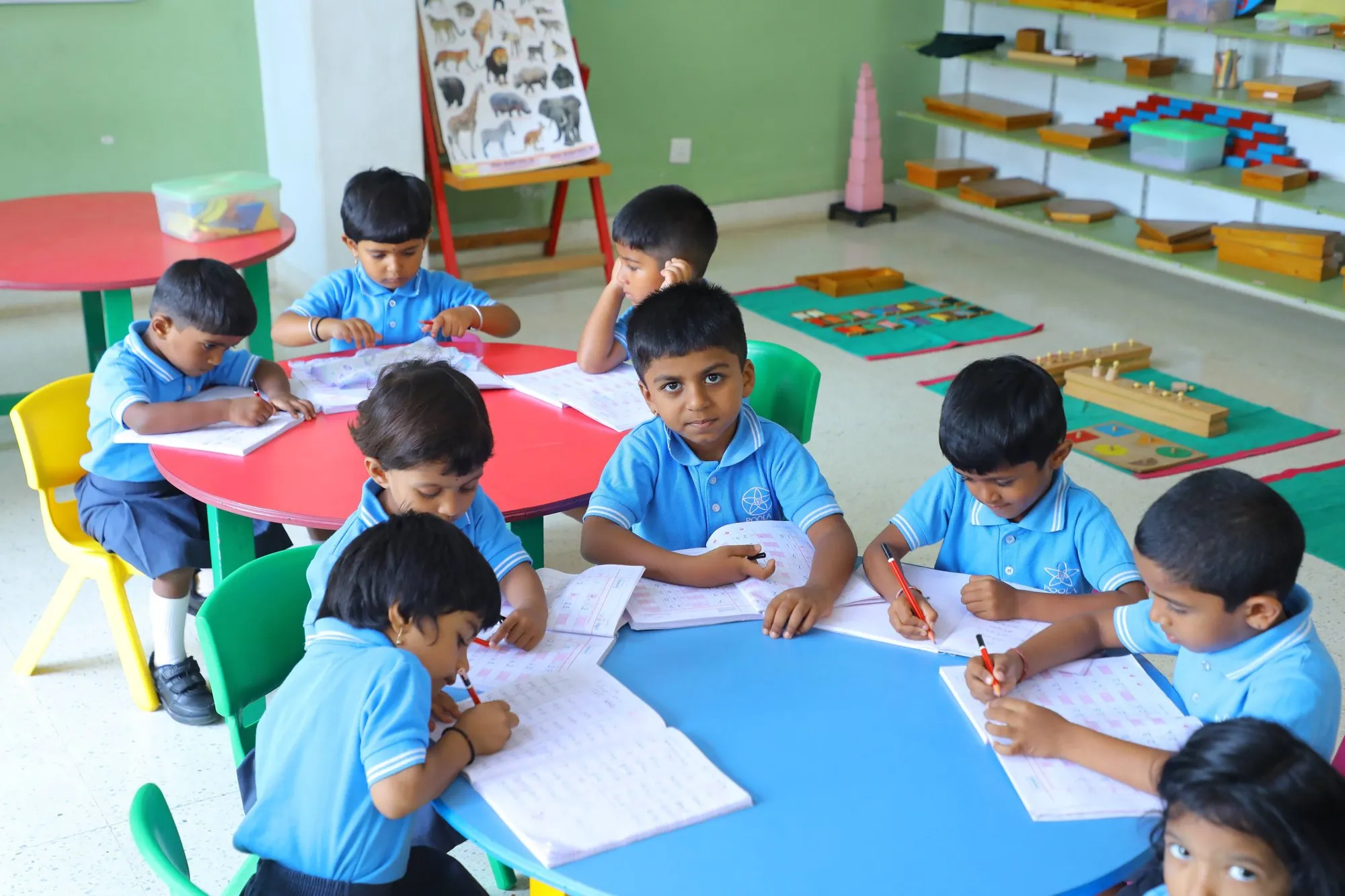 Elementary students writing together at their classroom table