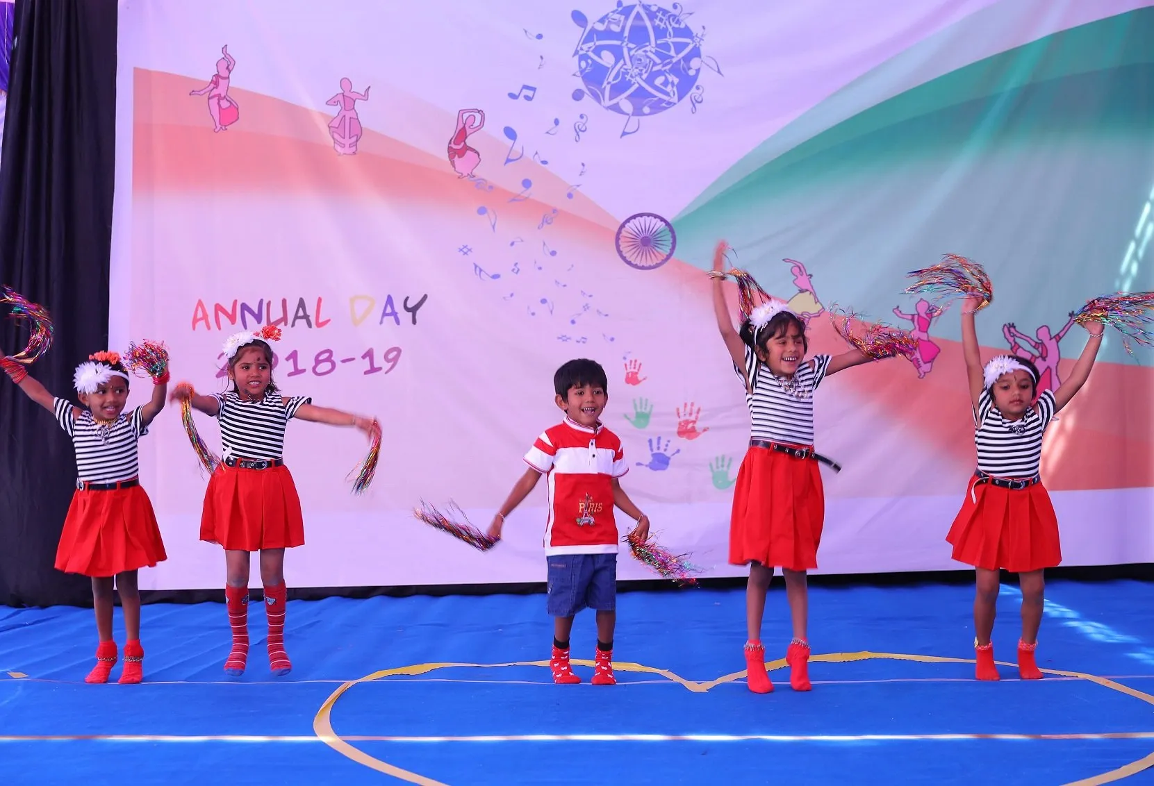 Young children performing a dance on stage