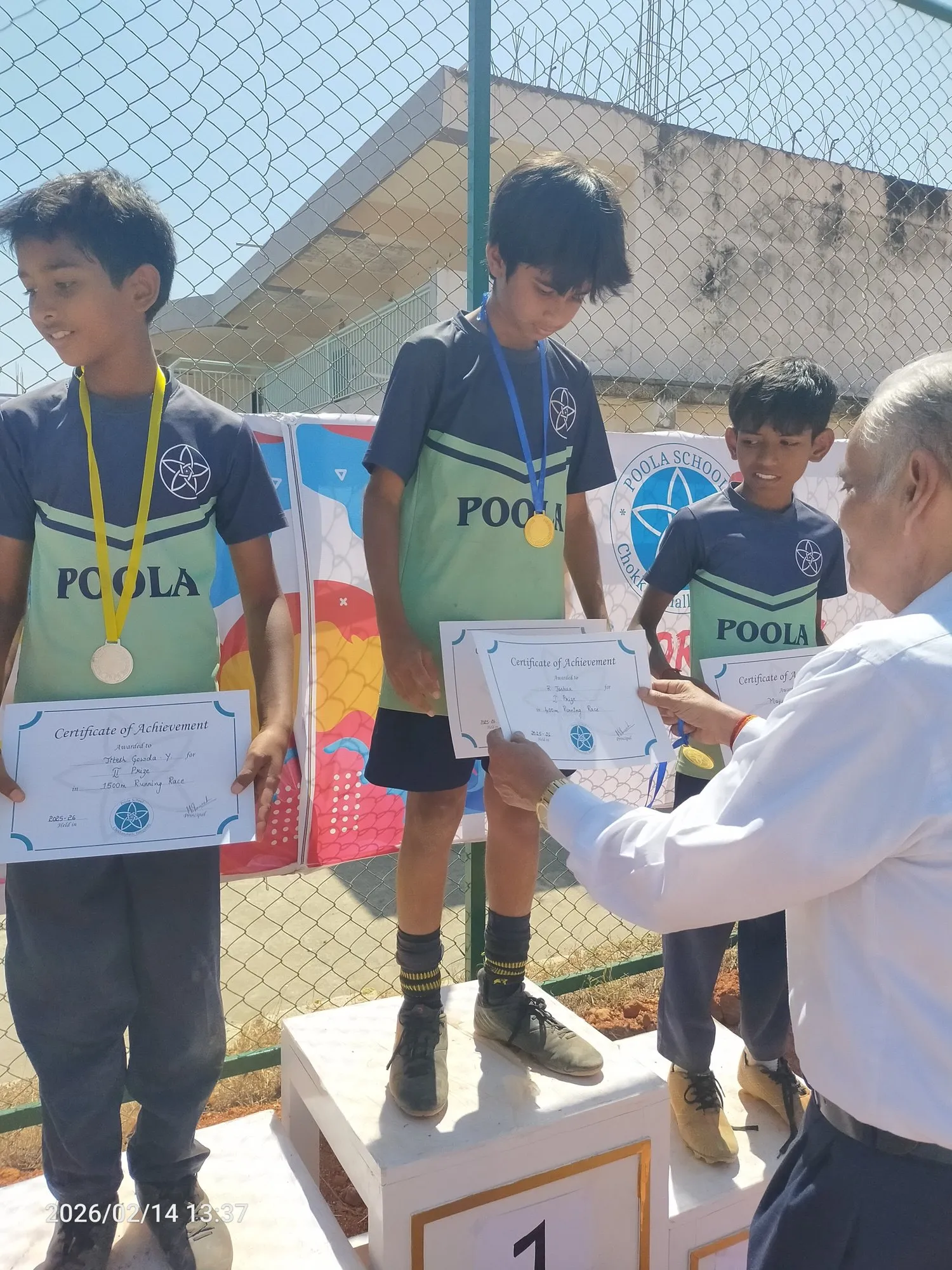 A student receiving a medal on the winners' podium