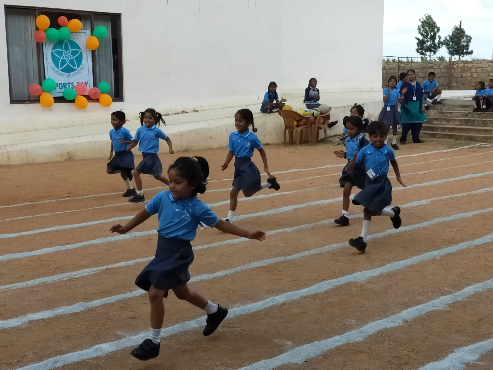 Students sprinting down the marked track on sports day